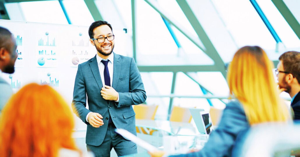 Business meeting with confident leader in modern office, focused heart-centered team engagement and collaboration.