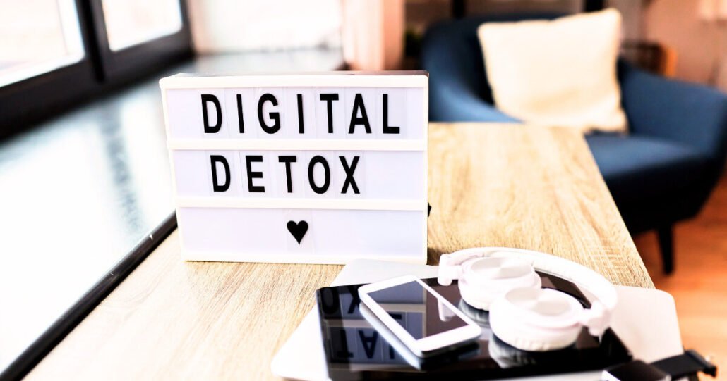 Modern cozy space promotes digital detox with a lightbox sign, natural lighting, and minimal decor.