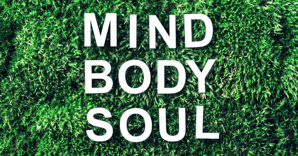 Mind Body Soul' text on green background promoting connection to life's answers.