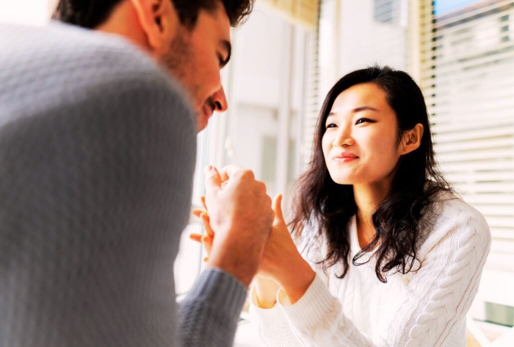 A warm conversation between a man and woman in a sunlit, intimate setting.
